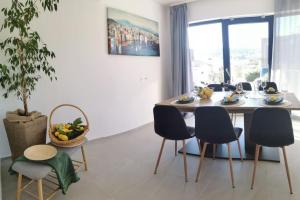 a dining room with a table and chairs at Villa Lemon Garden - Apartment in Dubrovnik in Mlini