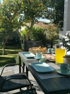 a table with plates of food and drinks on it at Villa Lemon Garden - Apartment in Dubrovnik in Mlini