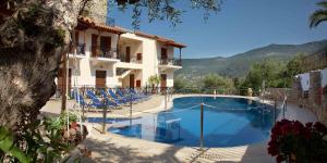 a large swimming pool in front of a building at Hotel Liakoto in Kardamili