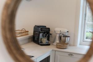 a kitchen with a coffee maker on a counter at Landhaus John in Oldsum +42 photos