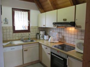 una pequeña cocina con fregadero y microondas en Nordwind - a78290 en Dorum Neufeld