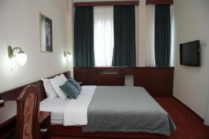 Postel nebo postele na pokoji v ubytování Palace Hotel