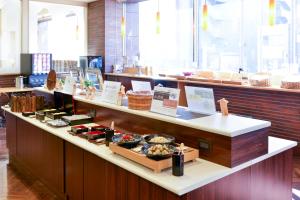 a bakery with a buffet of food on a counter at Hotel Keihan Asakusa in Tokyo