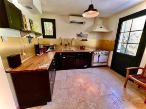 a kitchen with a sink and a counter top at Grand appartement en face du village in Moustiers-Sainte-Marie