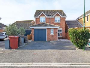 a red brick house with a garage at Cabane Mont Fort in East Wittering