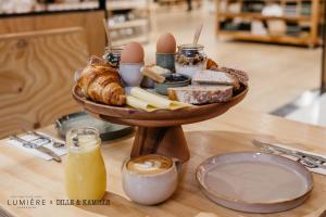 a tray of bread and pastries on a table at Boutique Hotel Lumiere in Eindhoven