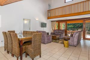 a living room with a table and chairs at San Lameer Villa 10301 - 4 Bedroom Classic - 8 pax - San Lameer Rental Agency in Southbroom