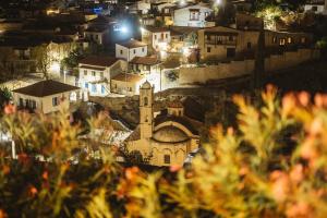 a view of a town at night with a church at Cyprus Villages Hotel & Restaurant - Central Location - Bed & Breakfast - With Access To Pool And Stunning Views in Tochni