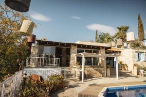 a house with a swimming pool in front of it at Cyprus Villages Hotel & Restaurant - Central Location - Bed & Breakfast - With Access To Pool And Stunning Views in Tochni