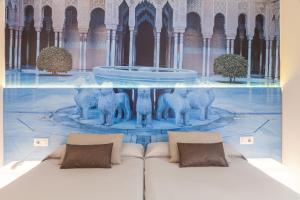 a room with a couch in front of a fountain at Hotel Macià Granada Five Senses Rooms & Suites in Granada