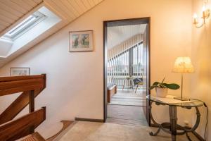 a hallway with a glass door leading to a balcony at Schwippl in Meckenbeuren