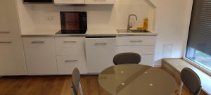 a kitchen with a table and a sink at Core Luxembourg City in Luxembourg