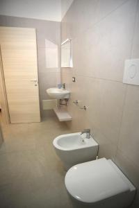 a bathroom with a toilet and a sink at Angelo Bianco Appartment in Porto Cesareo +42 photos
