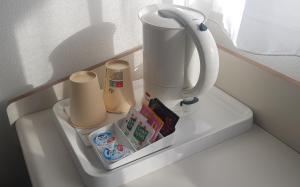 a white blender on a shelf in a refrigerator at Campanile Hotel Chantilly in Chantilly