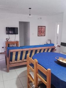 a bedroom with a blue bed and a table at Ayres Pampeanos in Santa Rosa