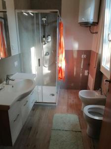 a bathroom with two sinks and a shower at House Of Music in Gardone Riviera