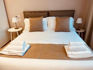 a bedroom with a bed with two towels on it at Urban Chic Home in Bari +13 photos