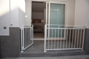 a hallway with a stairway leading to a room at Angelo Bianco Appartment in Porto Cesareo