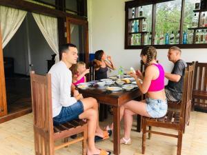 a group of people sitting around a table at Heritage villa polonnaruwa in Polonnaruwa
