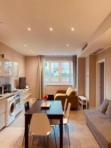 a kitchen and living room with a table and a couch at Urban Chic Home in Bari
