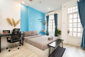 a bedroom with a bed and a desk and a chair at Friday Saigon Centre Homestay in Ho Chi Minh City