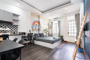 a living room with a bed and a kitchen at Friday Saigon Centre Homestay in Ho Chi Minh City