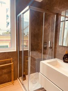 a shower stall in a bathroom with a sink at Urban Chic Home in Bari