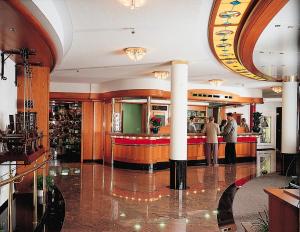 two people standing at a bar in a restaurant at Waldeck SPA Kur- & Wellness Resort in Bad Dürrheim