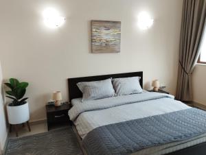 a bedroom with a bed with a blue comforter at Privat apartament Golf Coast in Kavarna +25 photos