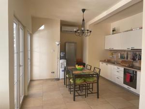 a kitchen with a table and chairs in a room at Villa Thetis in Bigovo