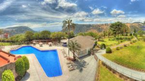 an aerial view of a house with a swimming pool at Hotel Quito in Quito