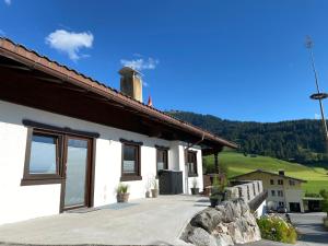 a white house with a large driveway at HauserA Appartement in Sankt Jakob in Haus