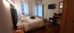 Postel nebo postele na pokoji v ubytování Hotel Lilla'