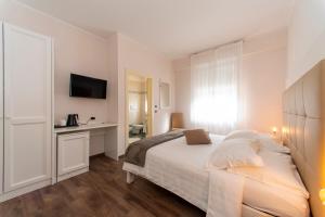 Postel nebo postele na pokoji v ubytování Hotel Lilla'