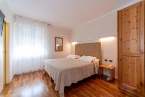 Postel nebo postele na pokoji v ubytování Hotel Lilla'