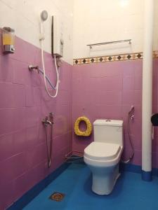 a pink bathroom with a toilet and a shower at The Maple Homestay @ Kota Laksamana Melaka in Melaka