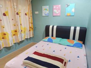 a childs bedroom with a bed with a black headboard at The Maple Homestay @ Kota Laksamana Melaka in Malacca