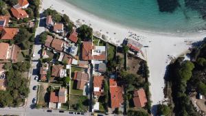 an aerial view of a beach with houses and the ocean at Casa Perdas - Gate to the Sea by Homey Experience in Olbia