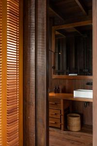 a bathroom with a sink and a mirror at Trebartha East The Round House in Ahangama