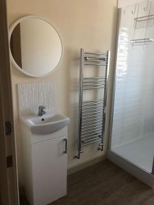 a bathroom with a sink and a mirror and a shower at Delightful 2 bedroom house between Bristol & Bath in Warmley