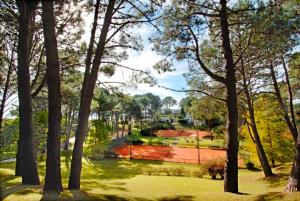 einen Tennisplatz in einem Park mit Bäumen in der Unterkunft Casa Dash Beach Houses in Punta del Este