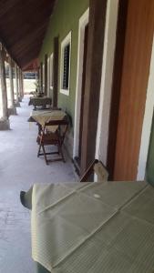a group of tables sitting outside of a building at Pousada e Restaurante Village Mantovani in Lavrinhas