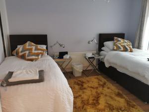 a bedroom with two beds and a rug at Over looking the bushmills distillery in Bushmills