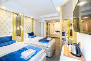 a hotel room with two beds and a mirror at Leslion Luxury Hotel in Antalya