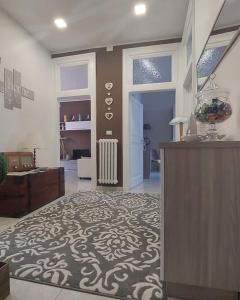 a living room with a large room with a rug at La Maison - Short Rental in Campobasso