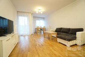 a living room with a couch and a table at Modern Apartment-City Center-New Building-Garage in Wrocław
