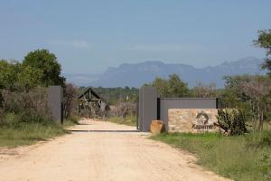a dirt road with a sign that reads kanza at Kapama River Lodge in Kapama Private Game Reserve