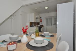 a dining room with a table with plates and candles at Entire 4-Bed House & Parking, Steps from ICC & City-Center & Broad Street in Birmingham