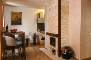 a living room with a fireplace and a dining room at Apartment Svetoslava in Pamporovo