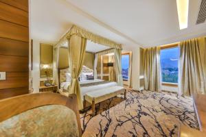 una camera con letto a baldacchino e finestre di The Kabo a Srinagar